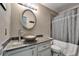 Updated bathroom with modern vanity, vessel sink, and shower-tub combo at 10719 Drummond Rd, Tampa, FL 33615