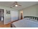 This bedroom offers a spacious closet, ceiling fan, and a serene view of the home's surroundings at 10719 Drummond Rd, Tampa, FL 33615