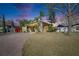 Charming home featuring a brick driveway, well-maintained lawn, and lush landscaping at 10719 Drummond Rd, Tampa, FL 33615