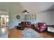 Cozy living room features hardwood floors, a ceiling fan, and comfortable leather seating at 10719 Drummond Rd, Tampa, FL 33615