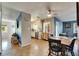 Open-concept living and kitchen area with tiled floor and modern ceiling fan at 10719 Drummond Rd, Tampa, FL 33615