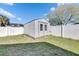 Charming shed with double doors and white picket fence at 10719 Drummond Rd, Tampa, FL 33615