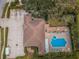 Aerial view showcases the pool with lounge areas, parking, and the building's layout at 1145 Dixon Ct, Dunedin, FL 34698