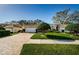 Charming single-story home featuring a well-manicured lawn, paver driveway, and attached two-car garage at 1145 Dixon Ct, Dunedin, FL 34698