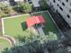 An aerial view of a well-maintained dog park area with a covered space and fenced border at 1208 E Kennedy Blvd # 1122, Tampa, FL 33602
