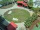 An aerial shot of a green space with sculptures and a covered seating area surrounded by palm trees at 1208 E Kennedy Blvd # 1122, Tampa, FL 33602