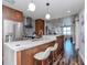 Modern kitchen featuring stainless appliances, stone countertops, and bar seating with pendant lighting at 1208 E Kennedy Blvd # 1122, Tampa, FL 33602