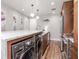 Modern kitchen with island, stone counters, stainless appliances, and light wood floors at 1208 E Kennedy Blvd # 1122, Tampa, FL 33602