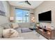 Cozy living room featuring a comfortable sectional, a mounted TV, and a bright window with city views at 1208 E Kennedy Blvd # 1122, Tampa, FL 33602