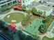 Aerial view of a pickleball court and green space with a covered seating area with mature palm trees at 1208 E Kennedy Blvd # 1122, Tampa, FL 33602