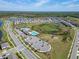 An aerial view of the community featuring a pool, playground, retention pond, and rows of single Gathering homes at 14733 Gallop Run Dr, Lithia, FL 33547