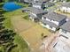 Aerial view of the backyard and a partially completed pool, with covered patio and landscaping at 14733 Gallop Run Dr, Lithia, FL 33547