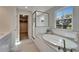 Bright bathroom with a soaking tub and walk-in closet at 14733 Gallop Run Dr, Lithia, FL 33547
