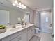 Clean bathroom with double vanity, white countertops, and shower-tub combo at 14733 Gallop Run Dr, Lithia, FL 33547