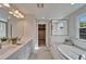 Bright bathroom with double vanity, soaking tub, and walk-in closet at 14733 Gallop Run Dr, Lithia, FL 33547