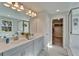 Bathroom with double vanity, tub, and walk-in closet access at 14733 Gallop Run Dr, Lithia, FL 33547