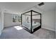 Spacious bedroom with carpeted floors, natural light, and a four-poster bed at 14733 Gallop Run Dr, Lithia, FL 33547