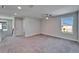 Spacious bedroom with plush carpet, ceiling fan, and natural light from the window at 14733 Gallop Run Dr, Lithia, FL 33547