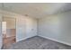 Cozy bedroom with neutral carpet, double door closet, and doorway leading to other rooms at 14733 Gallop Run Dr, Lithia, FL 33547