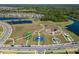 Aerial shot showcases the community park with splashpad, tennis courts, and picnic spots at 14733 Gallop Run Dr, Lithia, FL 33547