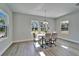 Bright dining room area featuring three large windows and a modern light fixture at 14733 Gallop Run Dr, Lithia, FL 33547