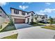 Charming two-story home with a stone facade, a well-manicured lawn, and a two car garage on a sunny day at 14733 Gallop Run Dr, Lithia, FL 33547
