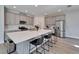 Modern kitchen with an oversized island, stainless steel appliances, and stylish gray cabinets at 14733 Gallop Run Dr, Lithia, FL 33547