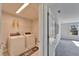Functional laundry room with modern washer and dryer, plus convenient shelving for storage at 14733 Gallop Run Dr, Lithia, FL 33547