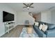 Cozy living room features modern furniture, plush seating and leads to an upstairs staircase at 14733 Gallop Run Dr, Lithia, FL 33547
