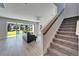 Bright living room has sliding doors to patio, backyard, and stairs to upper level at 14733 Gallop Run Dr, Lithia, FL 33547