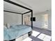 Spacious primary bedroom with a four-poster bed and ensuite access at 14733 Gallop Run Dr, Lithia, FL 33547