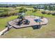 Aerial view of the community playground with a variety of play structures and equipment, with nearby homes at 14733 Gallop Run Dr, Lithia, FL 33547