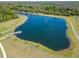 Aerial view of neighborhood pond with a long dock to walk along, surrounded by natural beauty at 14733 Gallop Run Dr, Lithia, FL 33547