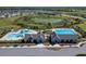 Aerial close up of community pool and clubhouse showing several different pools and modern building architecture at 14733 Gallop Run Dr, Lithia, FL 33547