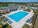 Aerial image of an Olympic sized swimming pool at the community center, surrounded by lounge chairs and tropical landscaping at 14733 Gallop Run Dr, Lithia, FL 33547