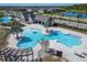 Overhead of the community pool featuring a freeform pool, lounge chairs and umbrellas, and a modern pool house at 14733 Gallop Run Dr, Lithia, FL 33547