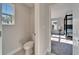 View from toilet room to bedroom featuring a four-poster bed at 14733 Gallop Run Dr, Lithia, FL 33547