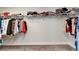 Bright walk-in closet offers generous storage with shelving and hanging racks in neutral colors at 14733 Gallop Run Dr, Lithia, FL 33547