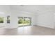 Bright living room with tile flooring and sliding glass doors to the backyard at 15547 Stuart Cir, Port Charlotte, FL 33981