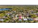 Aerial view of the house, surrounding neighborhood, and nearby lake at 15703 Jericho Dr, Odessa, FL 33556