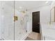 An elegant bathroom with a walk-in shower and gold fixtures, creating a luxurious experience at 15703 Jericho Dr, Odessa, FL 33556