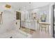 A luxurious bathroom featuring a glass walk-in shower, marble, and vanity area at 15703 Jericho Dr, Odessa, FL 33556