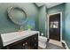 A stylish bathroom featuring a decorative mirror, modern vanity, and sophisticated fixtures at 15703 Jericho Dr, Odessa, FL 33556