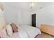 Bright bedroom featuring a plush bed with pillows and flamingo sheets, and a dresser on wood floors at 15703 Jericho Dr, Odessa, FL 33556