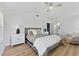 Bright bedroom with a ceiling fan, accent lighting, and a plush bed with soft pillows at 15703 Jericho Dr, Odessa, FL 33556