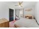 Cozy bedroom features a ceiling fan and accent rug at 15703 Jericho Dr, Odessa, FL 33556