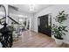Bright and welcoming foyer with hardwood floors, black staircase, and elegant chandelier at 15703 Jericho Dr, Odessa, FL 33556