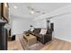 Comfortable living room with light wood floors, brick fireplace, flatscreen and plush seating at 15703 Jericho Dr, Odessa, FL 33556