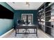 An elegant, well-lit office with a large desk, custom built-in shelving, and French doors at 15703 Jericho Dr, Odessa, FL 33556
