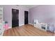 Playroom with wood flooring, storage shelving, and two doors at 15703 Jericho Dr, Odessa, FL 33556